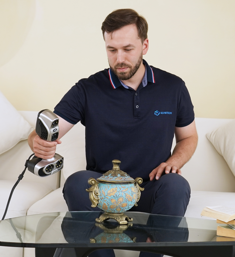 Technician scanning a metal vessel with a 3D scanner.